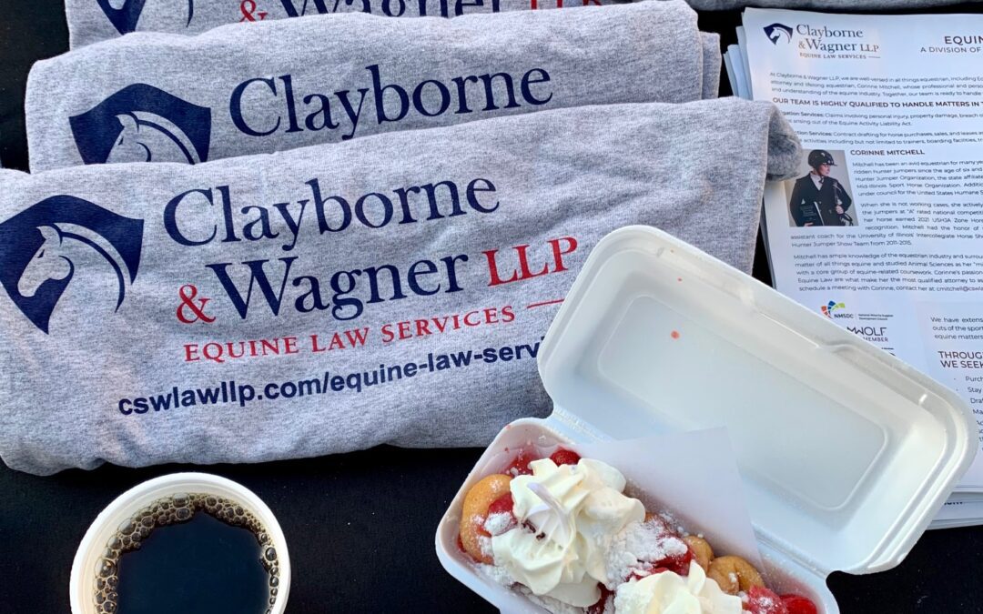 Clayborne and Wagner tshirts on a table with equestrian law brochures